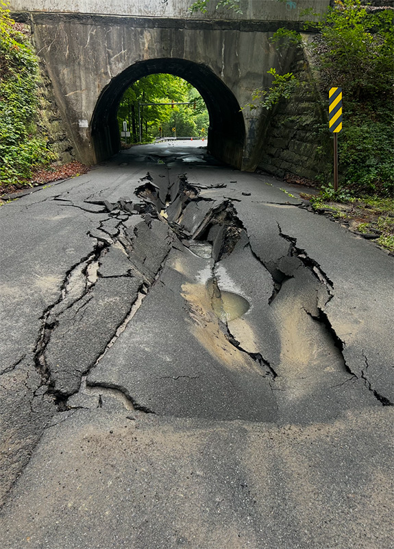 Large excavation and crater on Carlton Road during water main repairs