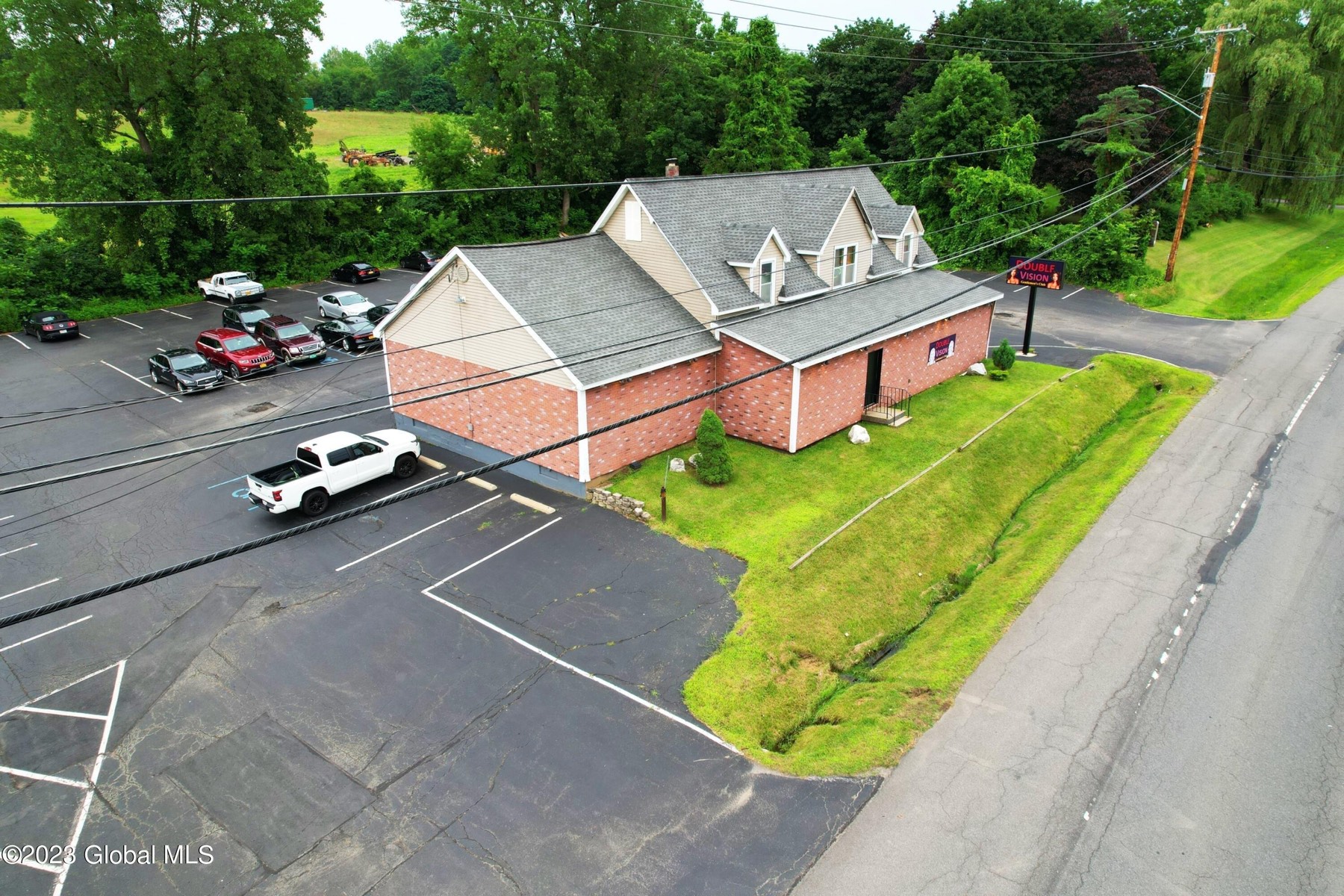 Aerial view of the Double Vision building at 1915 Route 9 in Halfmoon, with the parking lot and the highway in front